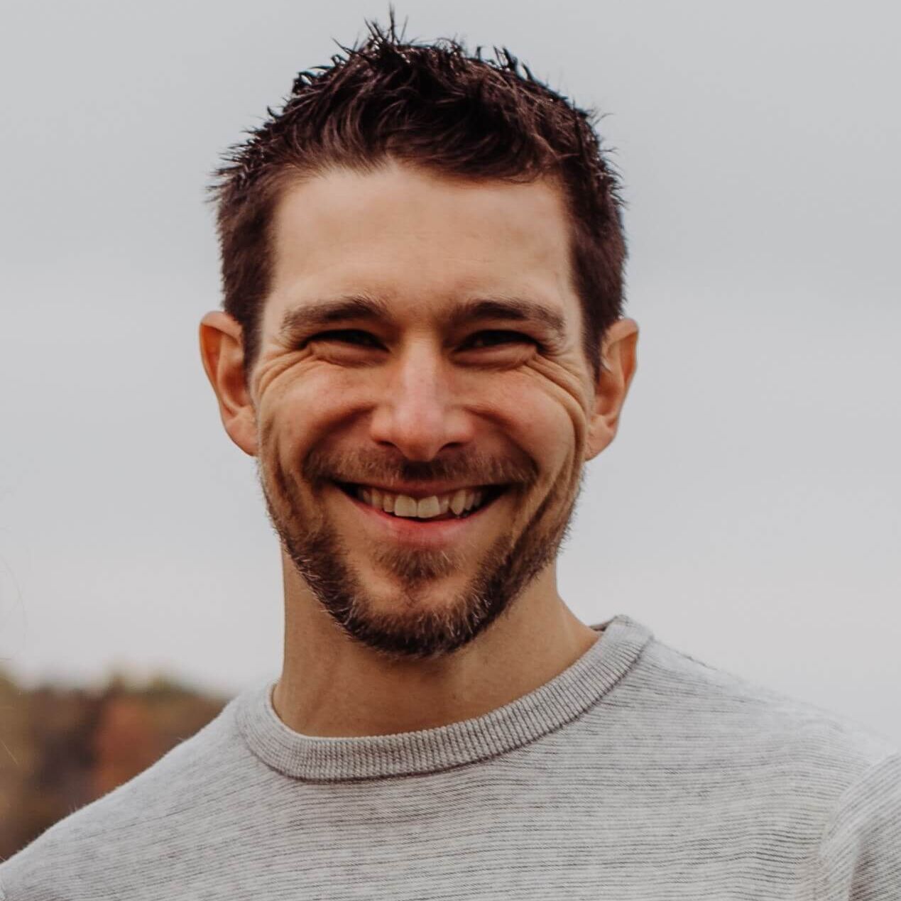 Adam Reimer, National Wildlife Federation Outreach and Evaluation Scientist, smiling in a professional headshot.